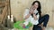 Young woman plays with tiny easter bunny, wooden basket full of rabbits and colorful eggs