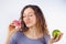 Young woman with pleasure eating a donut.