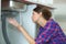 Young woman with plumber problem in kitchen