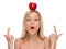 Young woman pointing on apple on head