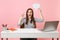 Young woman pointing finger up holding Say cloud speech bubble with lightbulb sit work at white desk with pc laptop