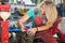 Young woman polishing nails in a mechanic shop