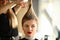 Young Woman with Ponytail Getting Haircut in Salon