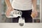 Young woman poring water from bottle to glass