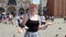 A young woman poses with a pigeon on her arm in St Marks Square  Venice  Italy