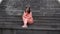 Young woman poses on stairs of manor. Adult female sitting on steps of Palace.