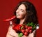 Young woman posing with fresh red vegetables radish pepper green