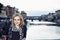 Young woman posing in front of amazing bridge Ponte Vecchio, Flo