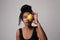 Young woman posing with lemon on white wall for skin and body care. Isolated.