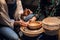 A young woman Potter helps a cute boy to make a gift for his mother out of clay.