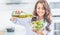 Young woman pouring olive oil in to the salad. Healthy lifestyle eating concept