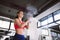 Young woman powder hands before exercise in the gym