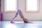 Young woman practice yoga indoor full body shot