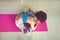 young woman practice yoga indoor shot bend forward in sit position from above