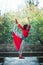 Young woman practice yoga outdoor autumn day lord of dance pose