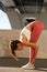 Young woman practice yoga stretch for spine and back outdoors. Beautiful athletic female do exercise