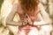 Young woman practices yoga and holding her hands behind her back