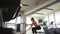 Young woman practicing with battle ropes in the gym