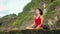 Young woman practicing morning meditation in nature at the beach. Pretty asian woman doing yoga on the ocean coast. Girl