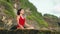 Young woman practicing morning meditation in nature at the beach. Pretty asian woman doing yoga on the ocean coast. Girl