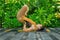 Young woman practicing Salamba Sarvangasana, Shoulderstand, inverted asana in hatha yoga. Legs in Lotus pose. Bali, Indinesia