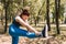 young woman practicing stretching exercises to gain flexibility outdoors. sporty woman preparing for a marathon. health