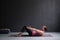 Young woman practicing yoga asana Ardha Navasana exercise at the yoga studio