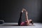 Young woman practicing yoga asana Ardha Navasana exercise at the yoga studio