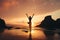 A young woman practicing yoga on the beach at sunset