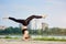 Young woman practicing yoga at city lake