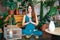 Young woman practicing yoga doing Ardha Padmasana exercise with namaste at home