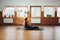 Young woman practicing yoga, doing Cobra exercise, Bhujangasana pose, working out, wearing sportswear, black pants and