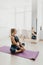 Young woman practicing yoga, enjoying morning home workout in Lotus pose on meditation time, full length, isolated, over white