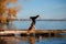 Young woman practicing yoga exercise at quiet wooden pier with c