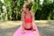 Young woman practicing yoga in a forest. Relax, mind and body