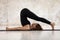 Young woman practicing yoga, Halasana exercise, Plough pose