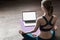 Young woman practicing yoga at home, online video training class, girl doing exercises and meditate
