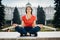 Young woman practicing yoga and meditation in park.Urban relaxation. Female meditating in a public park.Morning routine.Stress