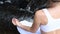 Young woman is practicing yoga and meditation sitting in lotus pose at waterfall in slow motion