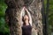 young woman practicing yoga outdoors