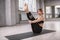 Young woman practicing yoga at sports studio