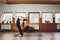 Young woman practicing yoga, standing in variation of head to knees exercise, uttanasana pose with hands behind back