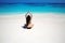 Young woman practicing yoga on the tropical beach with blue water and white sand. Lotus pose. Lifestyle. Relax. Meditation.
