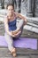 Young woman practicing yoga during yoga retreat in Asia, Bali, meditation, relaxation in abandoned temple