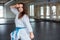 A young woman practising karate indoors in gym.