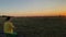 Young Woman Prays in Tranquil Meadow at Golden Hour