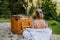 Young woman preapring to get into woodfired hot bath outdoors. Summer holidays in the mountains, hot water treatments