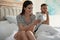 Young woman preferring smartphone over spending time with her boyfriend. Jealousy in relationship