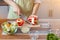 A young woman prepares bell peppers for her breakfast and is ready for a healthy meal on the table with healthy, organic