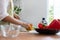 A young woman prepares bell peppers for her breakfast and is ready for a healthy meal on the table with healthy, organic